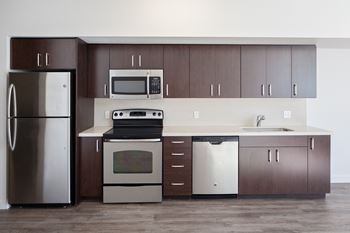 a kitchen with stainless steel appliances and wooden cabinets